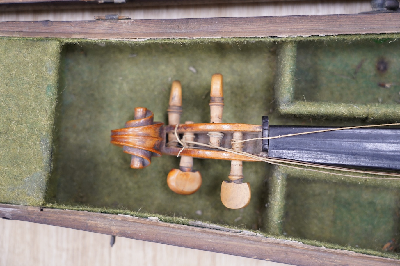 A late 19th century German violin, bearing a Stradivarius label, dated 1717, with mother of pearl inlaid tailpiece, in a walnut case and with bow, the bow stamped Vuillaume & Paris. Condition - fair